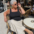 Woman in her sixties wearing the black built-in bra tank at a European cafe