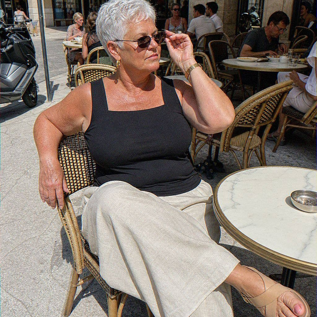 Woman in her sixties wearing the black built-in bra tank at a European cafe